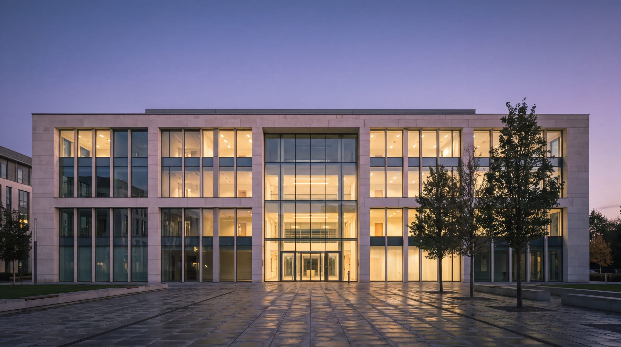 An office building lit from within at dusk